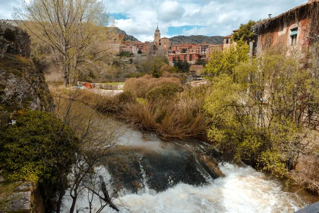 A quiet hillside town above a river, in spring light.