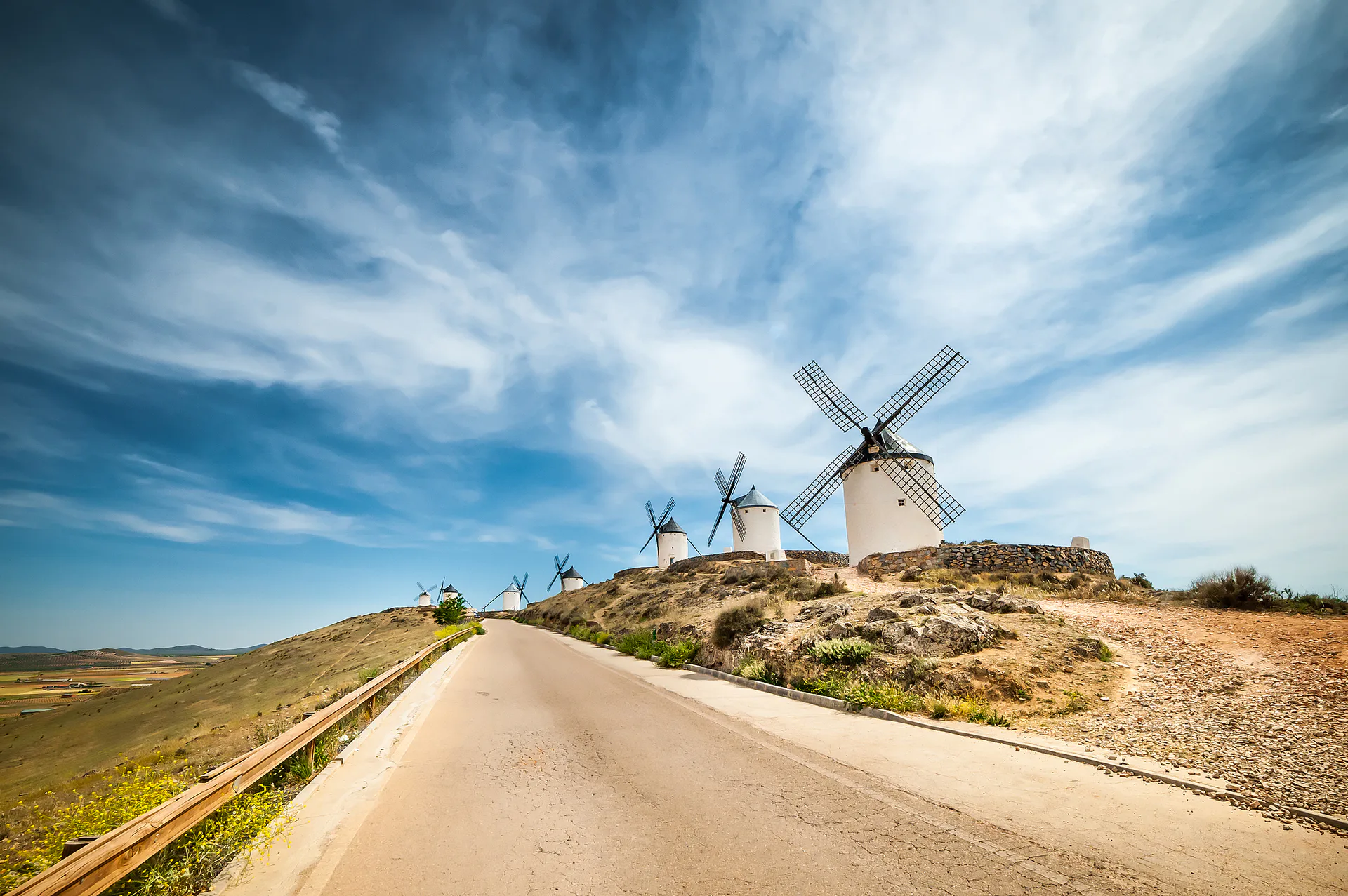White windmills along a ridge above open country.